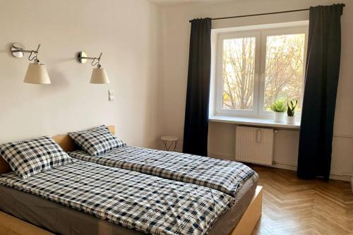 a bedroom with a bed and a window at Charming apartment in Old Mokotów in Warsaw