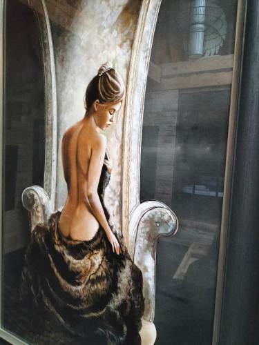 a painting of a woman sitting on a chair at L'idyle loft érotique détente in Callac