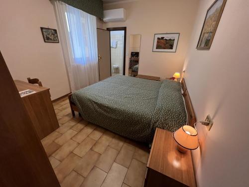 a small bedroom with a bed and a table at Viole Country Hotel in Assisi