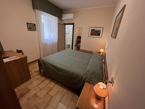 a small bedroom with a bed and a table at Viole Country Hotel in Assisi