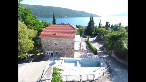 an aerial view of a house with a swimming pool at Vila Ćorović in Kumbor