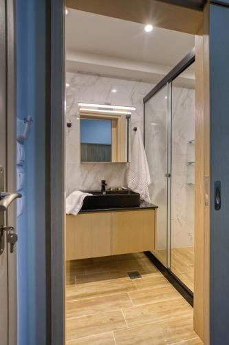 a bathroom with a sink and a mirror at Hersonissos Harbour View in Hersonissos