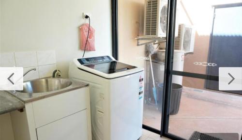 a small kitchen with a sink and a counter at The Ningaloo breeze villa 5 in Exmouth