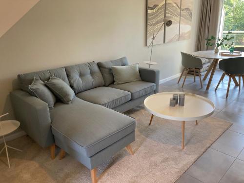 a living room with a couch and a table at Gästehaus Muhl in Strukkamp auf Fehmarn