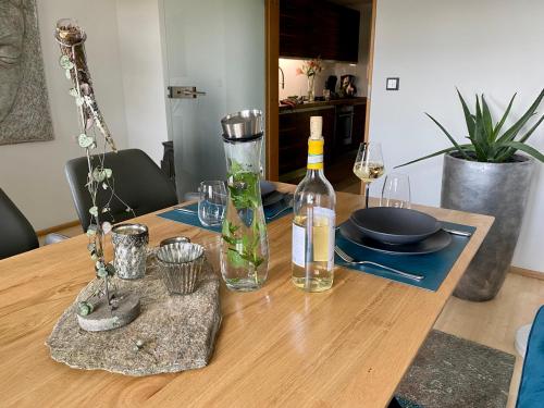 a wooden table with a bottle of wine and glasses at Atelier Tiedemann in Soltau