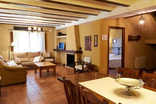a living room with a couch and a living room with a fireplace at Casas rurales Camaretas in Yeste