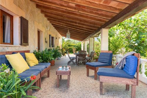 a patio with a couch and chairs and a table at Villa Lucas in Pollença