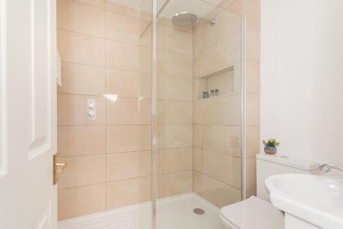 a bathroom with a shower with a toilet and a sink at Crescent Mews in Bath