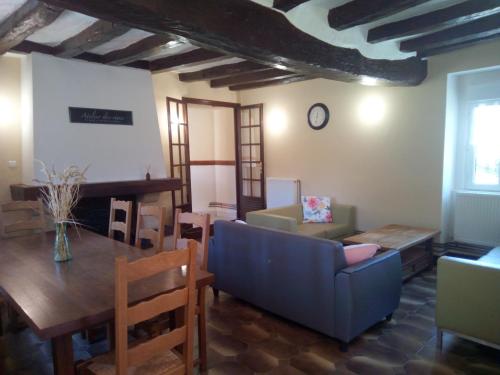 a living room with a blue couch and a table at GITE LA GRANDE AVALOUX in Artannes-sur-Indre