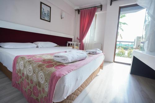 a hotel room with a bed and a large window at Halıcı Hotel Resort & SPA in Pamukkale