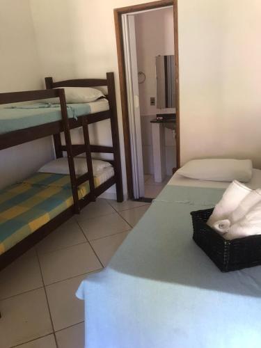a room with two bunk beds and a mirror at Céu Azul Pousada in Arraial d'Ajuda