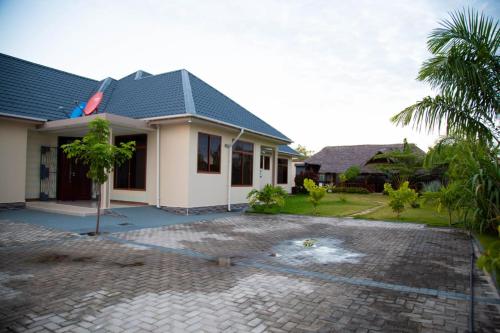 a house with a courtyard in front of it at Joleen Safari Park in Dar es Salaam