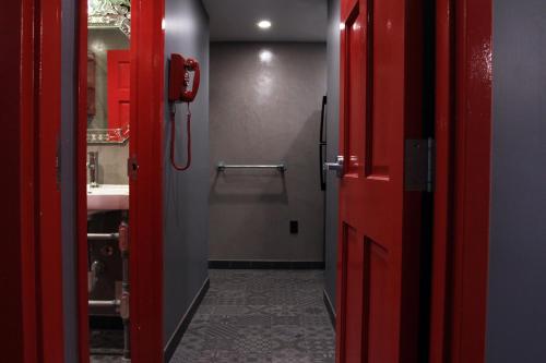 a bathroom with a red door and a sink at Crates at the Gaythering - Men Only in Miami Beach