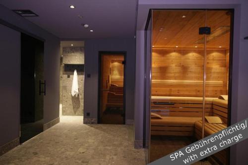 a room with a sauna with a purple wall at Hotel Stadt Breisach in Breisach am Rhein