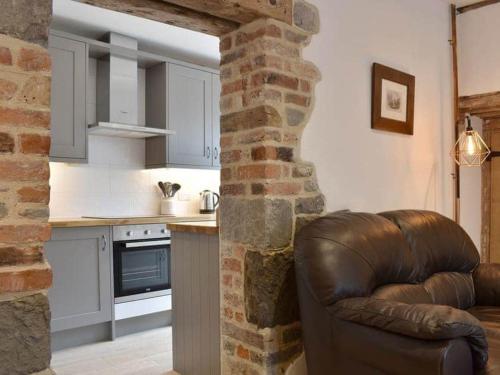 a living room with a leather couch in a kitchen at The Old Lyme Brewhouse in Lyme Regis