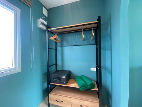 a bedroom with a bunk bed with blue walls at Le Petit Saint Tropez in Khanom
