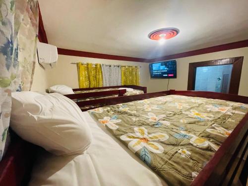 a bedroom with a bed with flowers on it at Lovely 2 Bedroom Condo With Pool And Hot Water in Cabarete