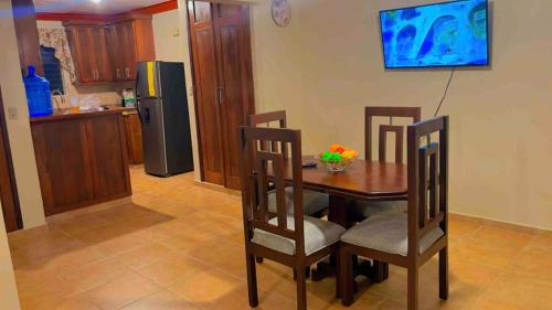 a kitchen with a table and chairs and a refrigerator at Lovely 2 Bedroom Condo With Pool And Hot Water in Cabarete