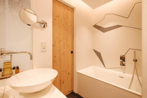 a bathroom with a white toilet and a sink at Best Western Chalet les Saytels in Le Grand-Bornand