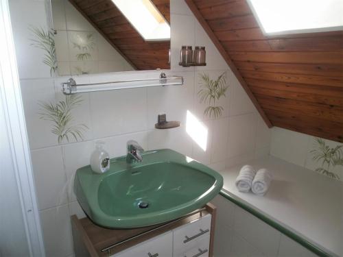 baño con lavabo verde en una habitación en Ferienanlage am See, en Buchberg bei Herberstein