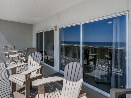 a balcony with chairs and a view of the ocean at Tidewater Orange Beach #202 in Orange Beach