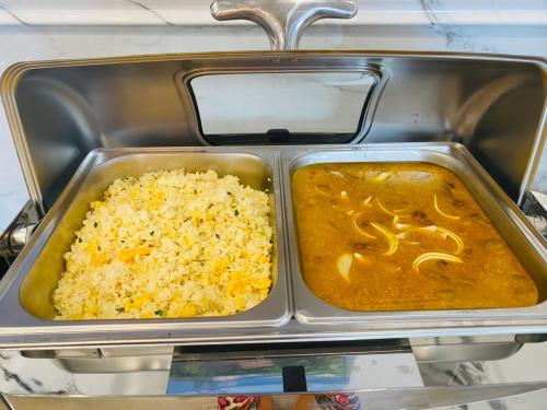 a tray of food with rice and sauce at Rockmila Hotel in Phu Quoc