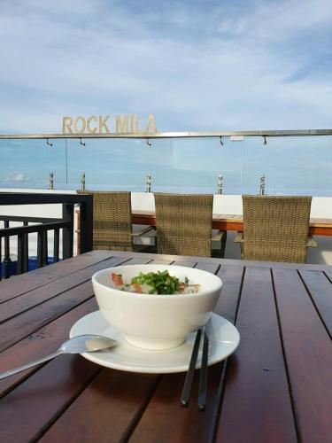 a bowl of soup sitting on a wooden table on a table gmaxwell gmaxwell at Rockmila Hotel in Phu Quoc