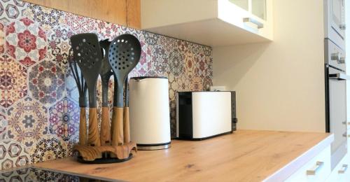 a kitchen counter with a bunch of utensils on it at Mein Apartment Flowers mit Kamin, bis 10 Personen in Frankenthal