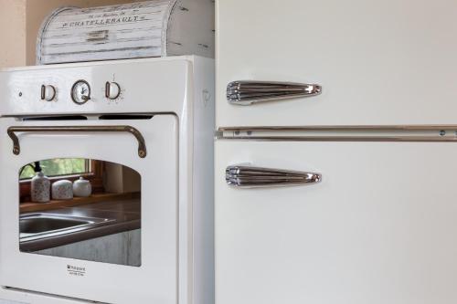 a white refrigerator freezer next to a sink at Dom z Widokiem Mucharz 405 in Mucharz