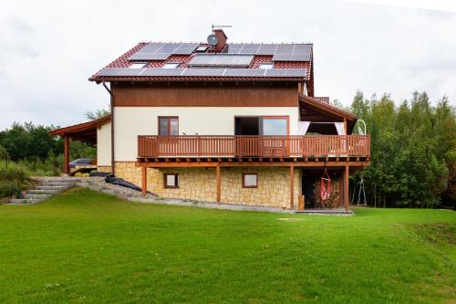 a house with solar panels on the roof at Dom z Widokiem Mucharz 405 in Mucharz