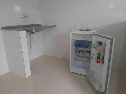 a small kitchen with a sink and a small refrigerator at Apart Hotel M6D in Rio Branco