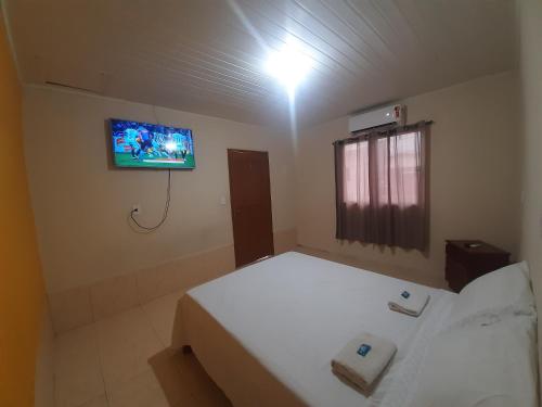 a bedroom with a bed and a tv on the wall at Apart Hotel M6D in Rio Branco