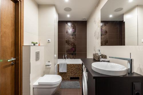 a bathroom with a toilet and a sink at Jekabpils 2 Apartment in Rīga