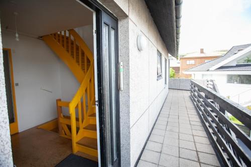 a balcony with a staircase and a stair case at The Bird / Guesthouse / 10 min Walk Downtown in Tórshavn