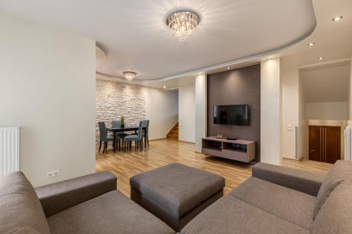 a living room with a couch and a table at Jekabpils 2 Apartment in Rīga
