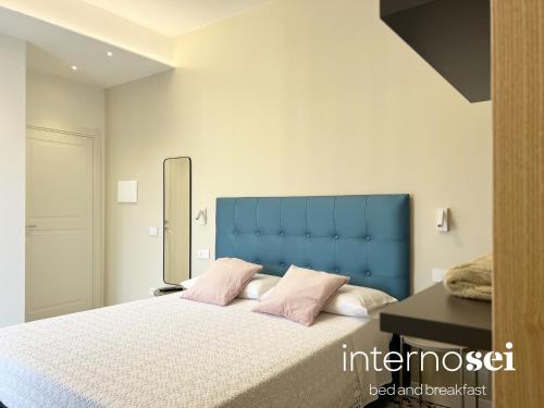 a bedroom with a large bed with pink pillows at Interno Sei B&B in Agropoli