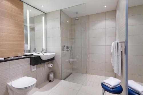 a bathroom with a toilet and a sink and a shower at Reykjavik Natura - Berjaya Iceland Hotels in Reykjavík