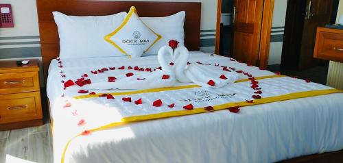 a bed with red hearts and towels on it at Rockmila Hotel in Phu Quoc