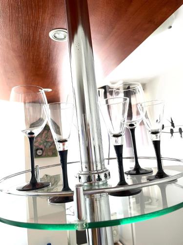 a group of wine glasses sitting on a glass table at Apartamenty przy Starówce in Olsztyn
