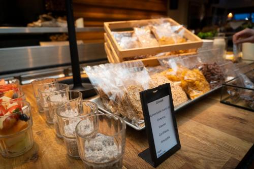 a table with glasses of food and a cell phone on it at Reykjavik Natura - Berjaya Iceland Hotels in Reykjavík