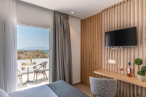 a hotel room with a view of the ocean at Ammolofos Luxury Apartment & suites in Naxos Chora
