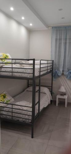 a bedroom with two bunk beds and a table at Villa Francesca in Catania