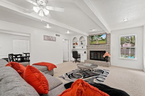 a living room with a couch and a fireplace at Luxury Pool House Near Lake w Pool Table in Garland