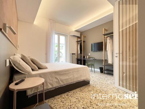 a bedroom with a large bed and a table at Interno Sei B&B in Agropoli