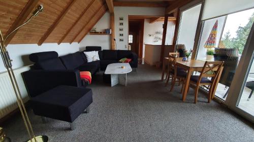 a living room with a couch and a table at Schau ins Land in Elbingerode