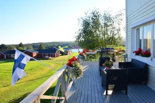 a porch with a flag and a house at Villa Sisu in Överkalix