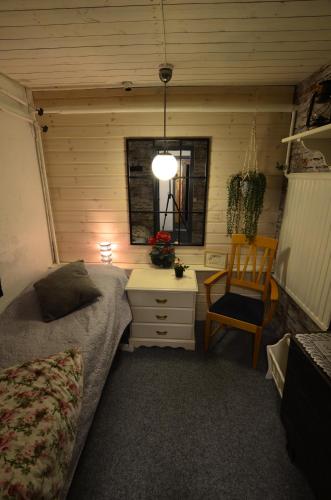 a bedroom with a bed and a desk and a chair at Villa Sisu in Överkalix