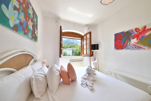 a room with a white bed and a window at Villa Marecoco in Ischia