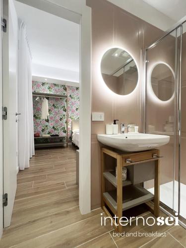a bathroom with a sink and a mirror at Interno Sei B&B in Agropoli