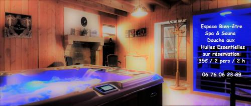 a large tub in a room with a sign on the wall at camping de la chagnée in Saint-Aubin-le-Cloud